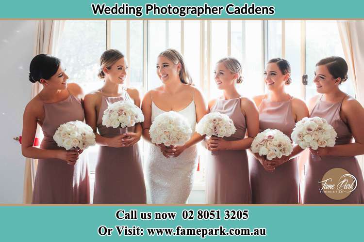 Photo of the Bride and her bridesmaids each holding a bouquet of flowers Caddens NWS 2747