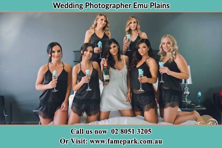 Bride and her bride's maid holding wine in bed Emu Plains NSW 2750