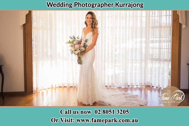 Bride holding bouquet of flowers near the window Kurrajong NSW 2758