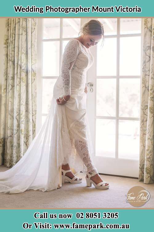 Photo of the Bride looking at her shoes Mount Victoria