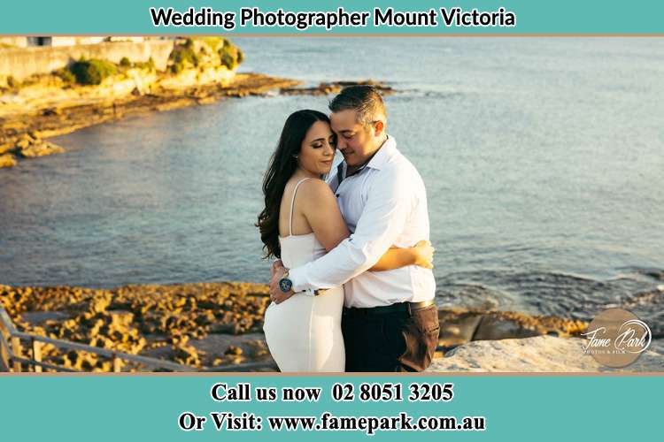 Photo of the Bride and Groom hugging Mount Victoria