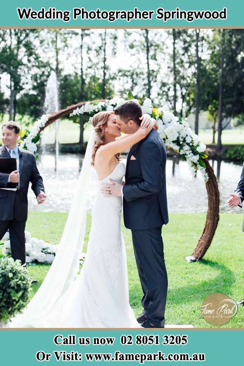 Photo of the Bride and the Groom kiss at the wedding ceremony Springwood