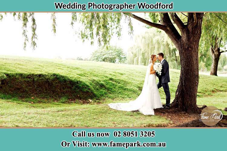 Photo of the Bride and Groom Under the tree Woodford